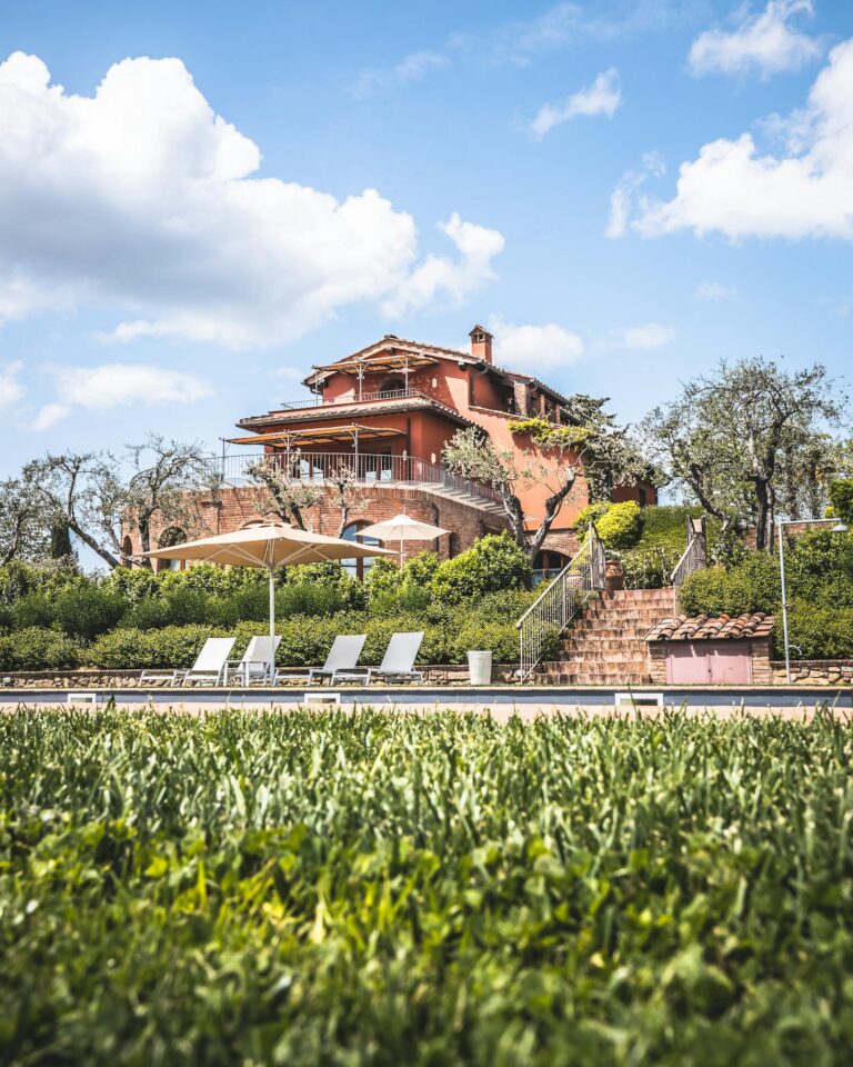 A beautiful villa and garden under blue skies, perfect for a serene vacation.