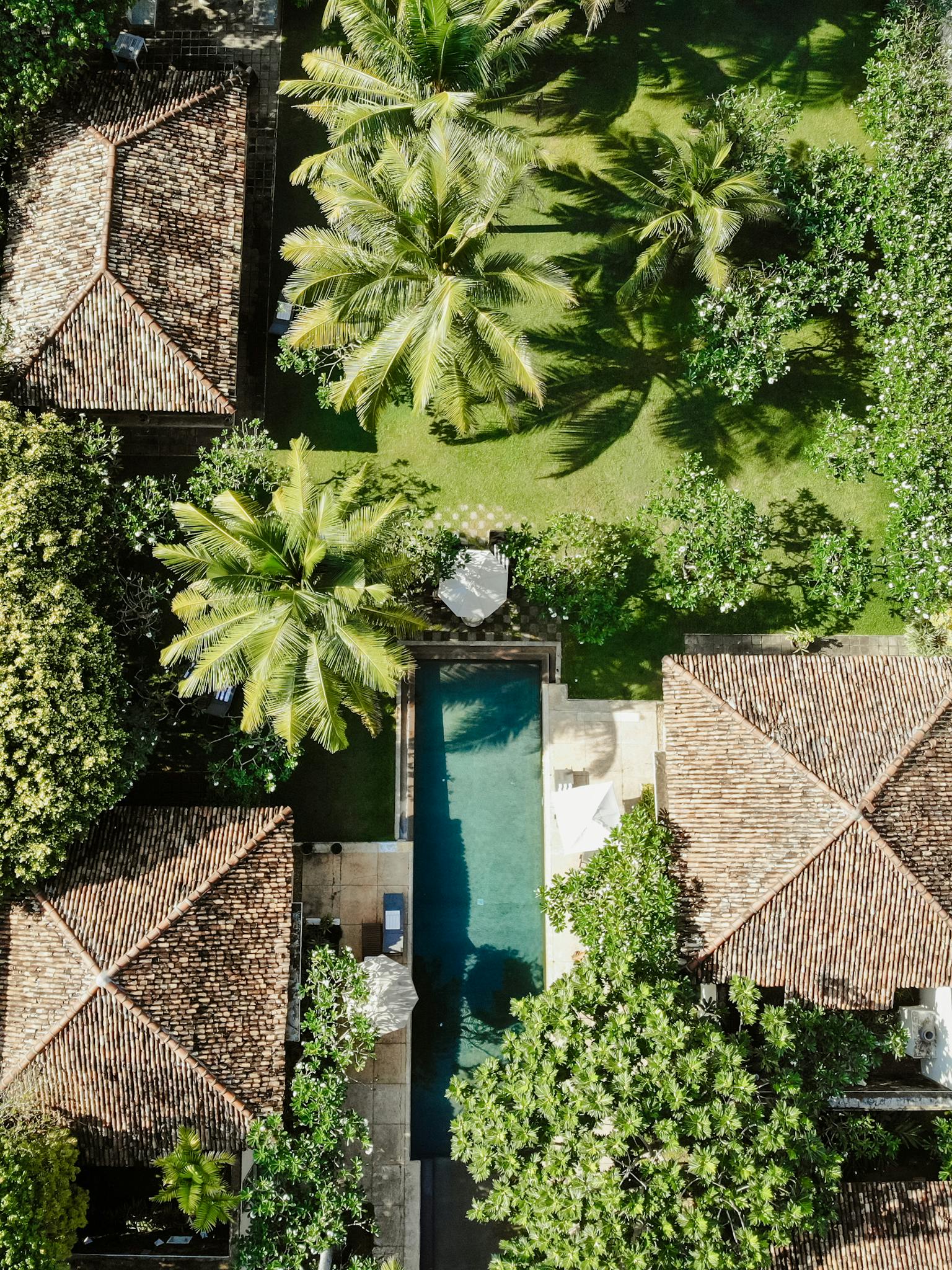 Aerial shot of lush gardens, villas, and a swimming pool in Galle, Sri Lanka.