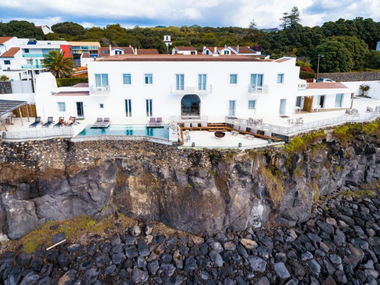 Stunning white villa on a cliffside with pool overlooking the sea in the Azores.